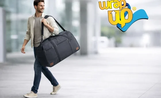 Adult traveler carrying a waterproof duffel bag in an airport, shown as a practical alternative to a rolling suitcase