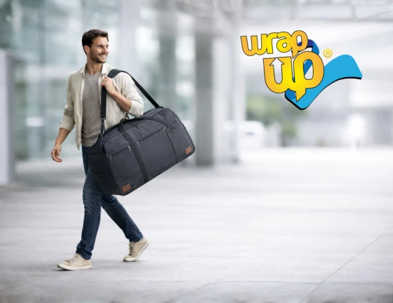 Adult traveler carrying a waterproof duffel bag in an airport, shown as a practical alternative to a rolling suitcase