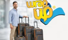Adult traveler standing next to affordable luggage sets with softside rolling suitcases in a modern airport setting