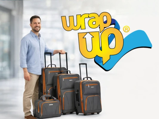 Adult traveler standing next to affordable luggage sets with softside rolling suitcases in a modern airport setting