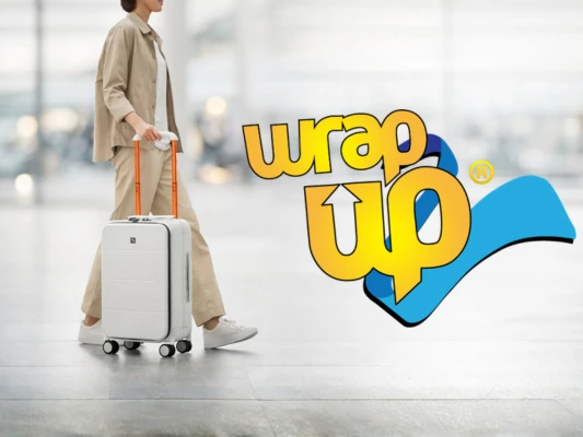 Traveler pulling hard shell carry on in airport, ideal best cabin luggage Europe size compliant