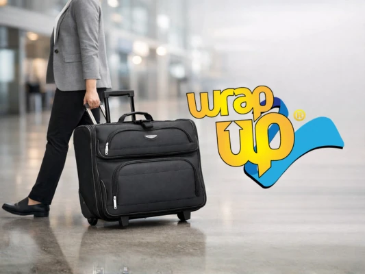 Professional traveler pulling a rolling garment bag through an airport terminal for business travel