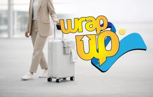 Traveler pulling underseat luggage with wheels through airport terminal