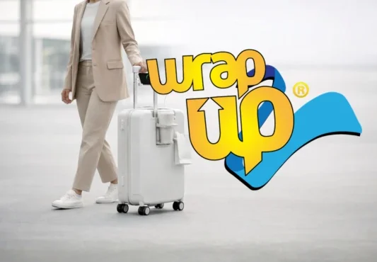 Traveler pulling underseat luggage with wheels through airport terminal