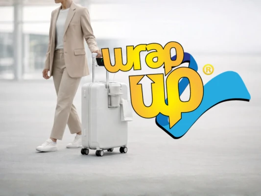 Traveler pulling underseat luggage with wheels through airport terminal