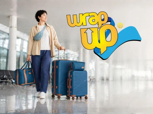 Traveler walking in airport with affordable luggage sets under 150 including suitcase and duffel bag