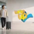 Traveler pulling expandable luggage with straps in a modern airport terminal