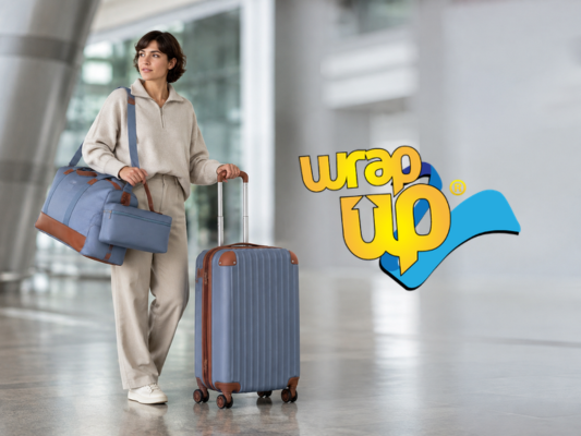 Woman traveling with rolling suitcase and matching bags, ideal luggage for solo women at the airport.