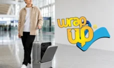 Traveler with carry-on luggage featuring a separate laundry compartment in a modern airport