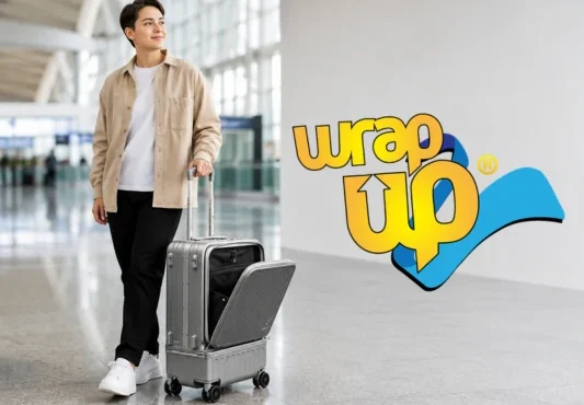 Traveler with carry-on luggage featuring a separate laundry compartment in a modern airport