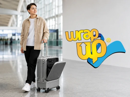 Traveler with carry-on luggage featuring a separate laundry compartment in a modern airport