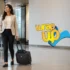 Business traveler pulling a wheeled laptop bag for travel through a modern airport terminal