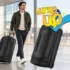 Traveler pulling a wheeled duffel bag through a modern airport terminal for easier travel