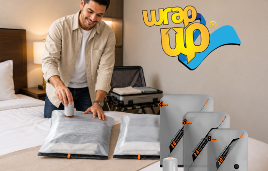 Traveler using compression travel storage bags on a bed while organizing clothes for a trip.