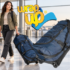 Traveler pulling a large wheeled duffel bag through an airport, ideal for durable duffel bags for travel